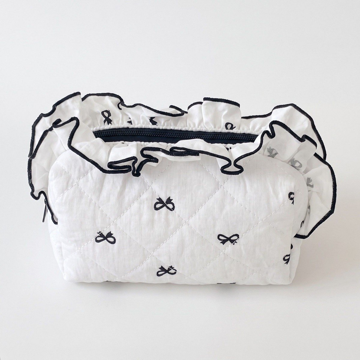 GUEST_fe7c56a9-d24b-49ba-a116-ceb11743e502.jpg Alilang Womens Quilted Bow Print Cosmetic Bag with Ruffle Trim - Black - Image 1